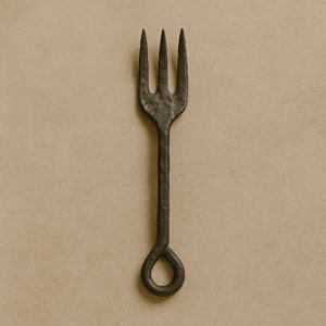 Hand-forged metal fork with a rustic design against a neutral background