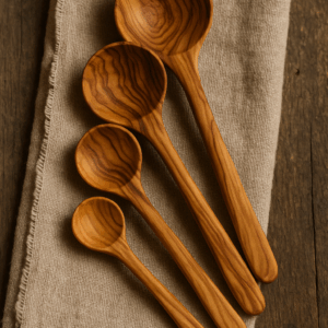 Olivewood Quantum Spoon Set consisting of multiple polished wooden spoons arranged neatly against a neutral background.